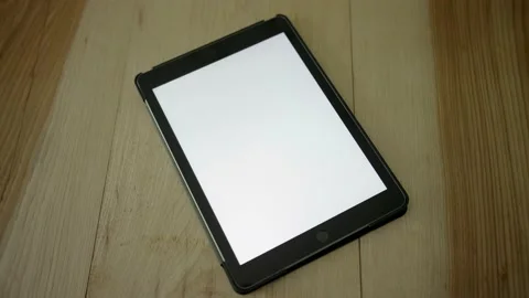Tablet on a wooden table Stock Footage 154506857