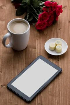 Tablet on wooden table Stock Photos