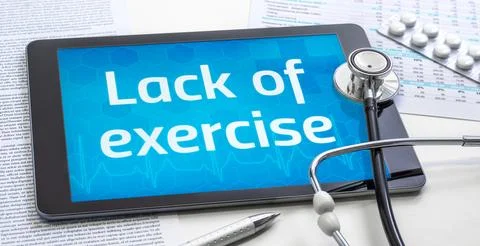 A tablet with the word lack of exercise on the display Stock Photos