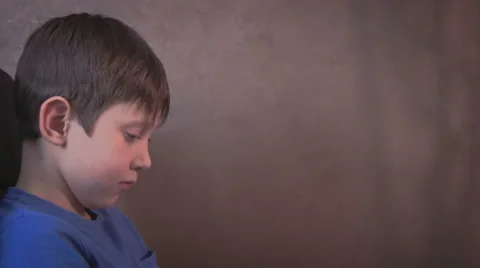Tablet young child boy sitting in the chair watching playing portable computer Stock Footage 59963688