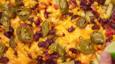 Tabletop cooking: chef sprinkles lime to the mexican spicy food, 4k Stock Footage 211738239