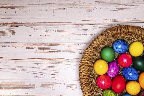Tabletop easter theme with copy space. Colorful easter eggs with basket Stock Photos