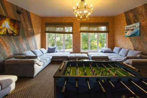 Tabletop football and empty sofas in spacious lounge zone Stock Photos