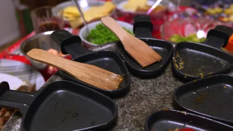 Tabletop grill with grilling plates filled with food being cooked and shared Stock Footage 323227025