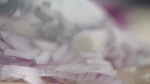 Tabletop Macro Close up of kitchen knife chopping onions in slow motion Stock Footage 273428256