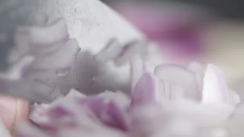 Tabletop Macro Close up of kitchen knife chopping onions in slow motion Stock Footage 273428305