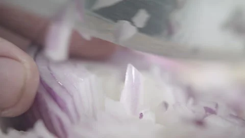 Tabletop Macro Close up of kitchen knife chopping onions in slow motion Stock Footage 273428307