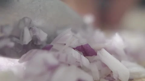 Tabletop Macro Close up of kitchen knife chopping onions in slow motion Stock Footage 273428919