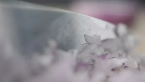 Tabletop Macro Close up of kitchen knife chopping onions in slow motion Stock Footage 273429585