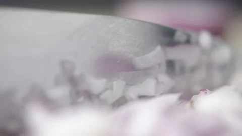 Tabletop Macro Close up of kitchen knife chopping onions in slow motion Stock Footage 273430016