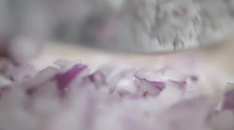 Tabletop Macro Close up of kitchen knife chopping onions in slow motion Stock Photos