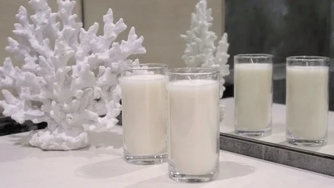 Tabletop with open book, candles, flowers in the glass bottle and shadows on the Stock-Footage 107956151