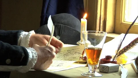 Tabletop, Quill dipping ink and writing by candle light &amp; by window, papers. Stock Footage 81236503
