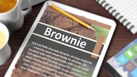 Tabletop with various objects focused on tablet with recipe of "Brownie" on s Stock Illustration