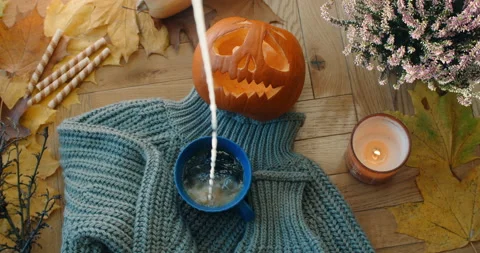 Tabletop video of adding milk to the black tea in slow motion, decorated autumn Stock Footage 166405093