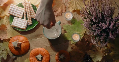 Tabletop video of stiring tea with milk in slow motion. Decorated autumn Stock Footage 164862151