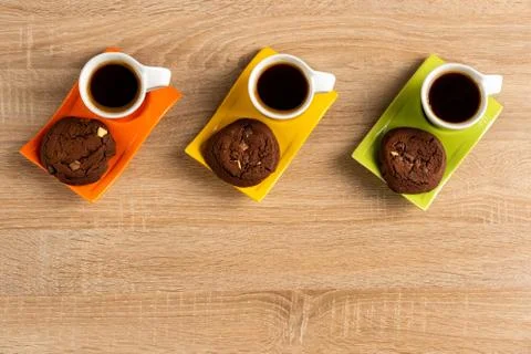Tabletop view of delicious chocolate biscuits and three cups of coffee Stock Photos