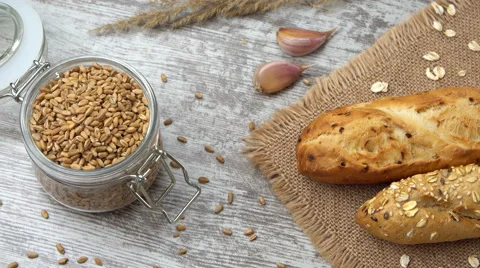 Tabletop view of fresh bread on the kitchen table. Healthy eating and Stock Footage