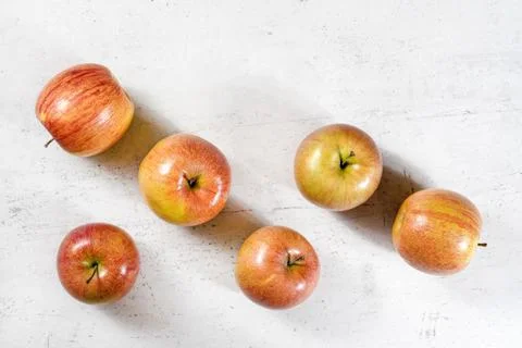 Tabletop view, six shiny apples (kiku variety) on white working board Foto stock