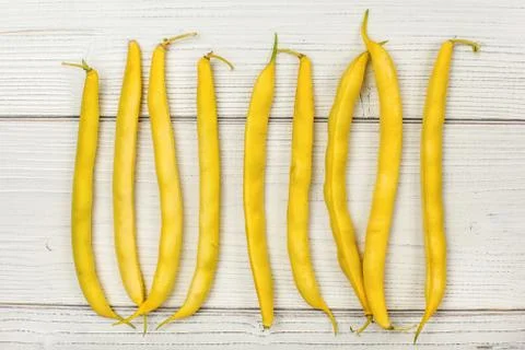 Tabletop view - yellow string (wax) beans on white boards. Stock Photos