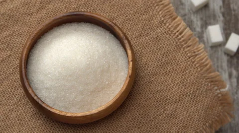 Tabletop of white sugar rotating on burlap. Four lumps of white sugar on rustic Video stock 67596980
