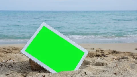 TabletPC with green screen on the beach 1 Stock Footage 126956965