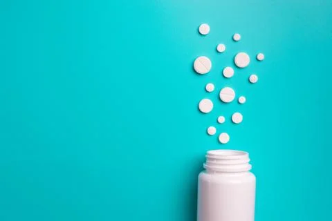 Tablets and bottle on blue background Stock Photos