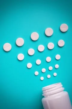 Tablets and bottle on blue background Stock Photos