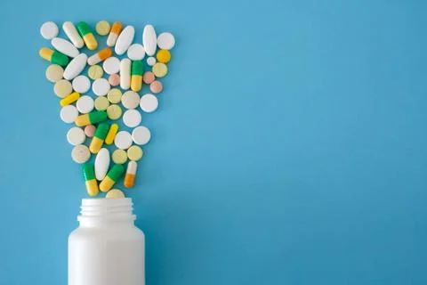 Tablets and capsules in form of cone from a can Stock Photos
