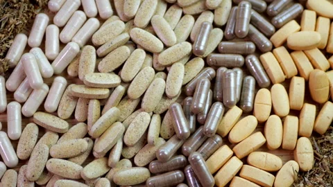 Tablets and capsules Herbal tablets Ayurvedic supplements Vitamins and minerals Stock Footage 293094714