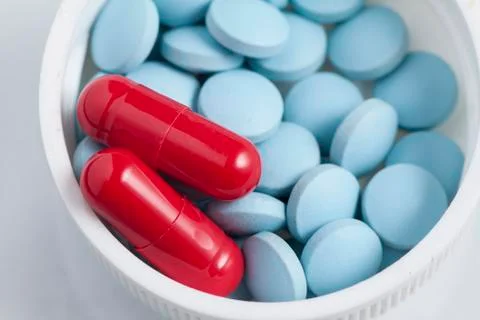 Tablets and capsules in the lid Stock Photos