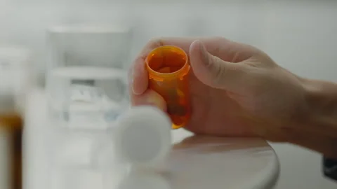 The tablets and capsules the patient needed were on the kitchen table, but h Stock Footage 259845714