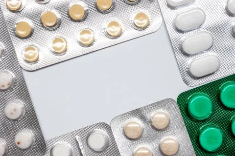 Tablets and pills in blisters making frame Stock Photos