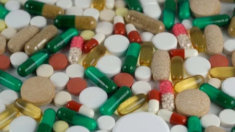 Tablets and pills rotate on a turntable Stock Footage 77210902