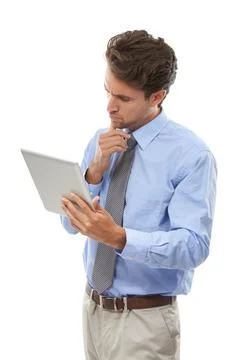 Tablets are business essentials. Studio shot of a young businessman using a Stock Photos