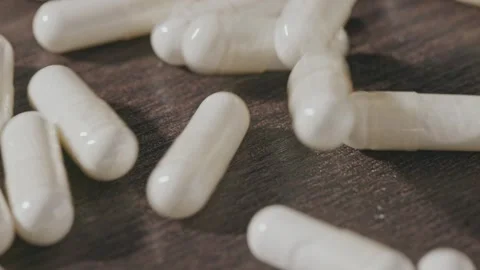 Tablets are pouring onto the table. Stock Footage 270413006