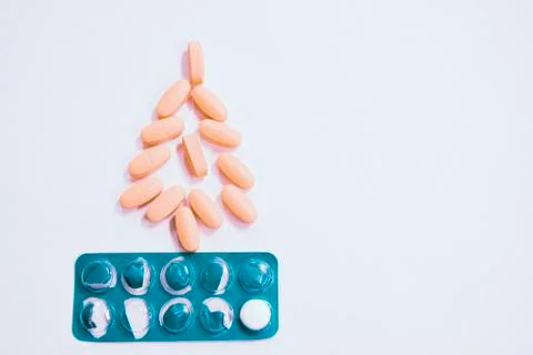 Tablets are presented in the shape of a Christmas tree on a white background. Stock Photos