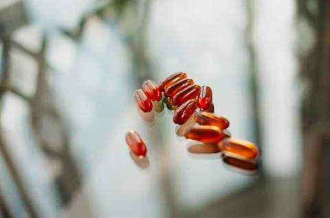 Tablets are scattered on a glass table with reflections. Stock Photos