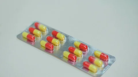 Tablets capsules in a blister packaging on a white background Stock Footage 124828010