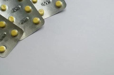 Tablets for colds on a gray background with copy space. Medicines. Means of Stock Photos