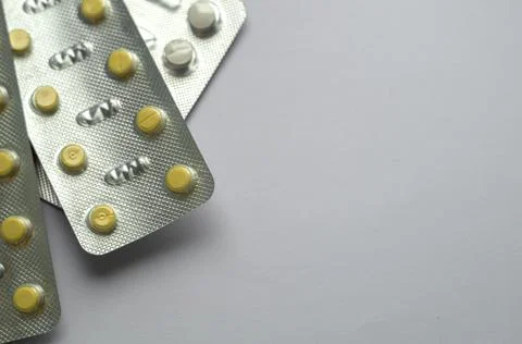 Tablets for colds on a gray background with copy space. Medicines. Means of Stock Photos