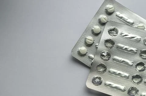 Tablets for colds on a gray background with copy space. Medicines. Means of Stock Photos