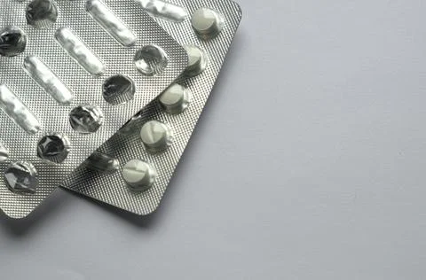 Tablets for colds on a gray background with copy space. Medicines. Means of Stock Photos