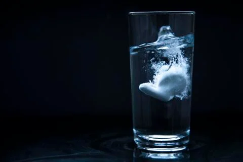 Tablets dissolving in water Stock Photos