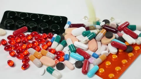 Tablets fall on the table. A lot of pills. Pharmacy Stock Footage 100043368