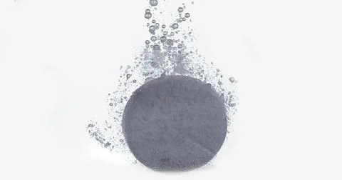 Tablets Falling and Dissolving into a Glass of Water against White Background Stock Photos