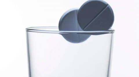 Tablets Falling into a Glass against White Background, Slow Motion Stock Footage