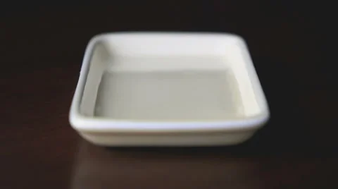 Tablets in the form of capsule fall on a plate Видео 61841744