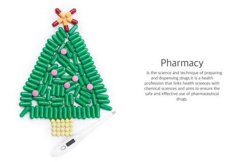 Tablets in form of Christmas tree and thermometer under it Stock Photos