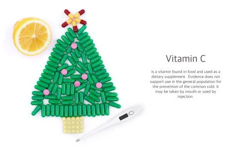 Tablets in form of Christmas tree thermometer and lemon underneath Stock Photos